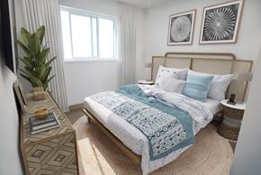 Kapolei apartment for rent - A bedroom with a bed, a nightstand, and a plant.