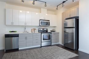 Seattle apartment for rent - a kitchen with white cabinets and stainless steel appliances