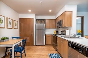 Lacey apartment for rent - a kitchen with stainless steel appliances and a dining room table