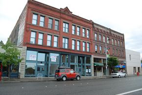 Bellingham apartment for rent - a red brick building on a city street with a car parked in front of it