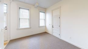Bellingham apartment for rent - a bedroom with a door and two windows and a carpeted floor