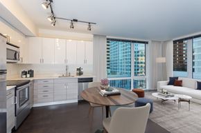 Seattle apartment for rent - a living room with a kitchen and a large window