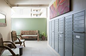 Honolulu apartment for rent - a locker room with a bench and chairs and filing cabinets