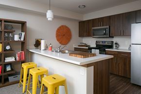 Lynnwood apartment for rent - a kitchen with yellow bar stools and a counter top