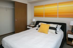 Lynnwood apartment for rent - a bedroom with a bed and three orange paintings on the wall