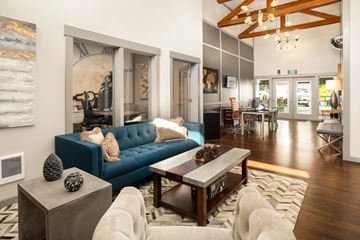 Federal Way apartment for rent - A blue couch sits in a living room with a wooden coffee table in front of it.