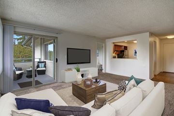 Shoreline apartment for rent - A living room with a white couch and a flat screen TV.