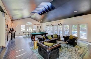 Shoreline apartment for rent - A living room with a black couch and a blue rug.