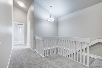 Issaquah apartment for rent - A white staircase with a carpeted floor.