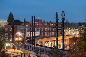 Seattle apartment for rent - a train on a track in front of a building