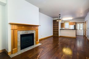 Seattle townhouse for rent - a living room with a fireplace and wooden floors