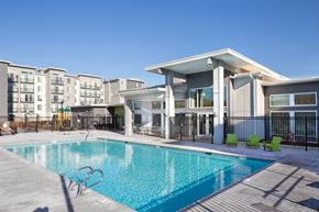 Auburn apartment for rent - a swimming pool in front of a apartment building with a pool