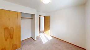 Bellingham apartment for rent - a bedroom with a door to a wardrobe and a carpeted floor