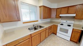 Bellingham apartment for rent - a kitchen with wooden cabinets and a sink and a stove