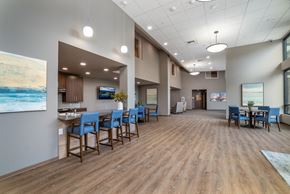 Lacey apartment for rent - a large dining room with blue chairs and a bar and a table with chairs