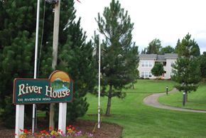 Lynden apartment for rent - a sign for the river house with a building in the background