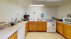 Lynden apartment for rent - a kitchen with white appliances and wooden cabinets