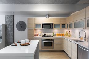 Seattle apartment for rent - a kitchen with wooden cabinets and stainless steel appliances