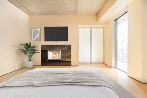 Seattle apartment for rent - a bedroom with a bed and a fireplace     and a tv