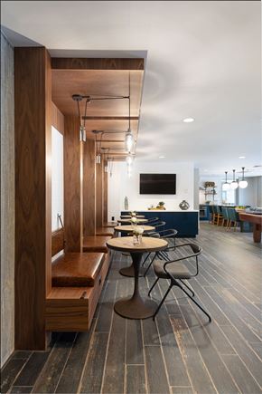 Seattle apartment for rent - a dining room with tables and chairs and a wall with a television