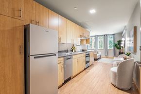 Bothell apartment for rent - A modern kitchen with wooden cabinets and stainless steel appliances.