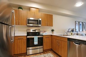 Seattle apartment for rent - a kitchen with stainless steel appliances and wooden cabinets