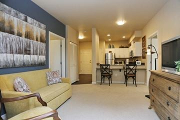 Seattle apartment for rent - a living room and kitchen with a couch and a tv