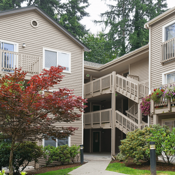 Issaquah apartment for rent - A tree with red leaves is in front of a building.