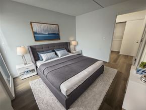 Waipahu apartment for rent - A bedroom with a large bed and a painting on the wall.