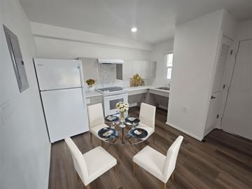 Waipahu apartment for rent - A kitchen with a table and chairs in the middle.