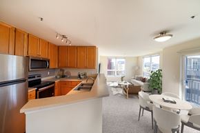 Seattle apartment for rent - A kitchen with wooden cabinets and a white counter.