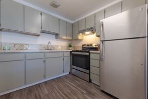 Seattle apartment for rent - a kitchen with white cabinets and stainless steel appliances