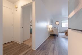 Seattle apartment for rent - a living room and hallway with a door to a bedroom