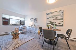 Seattle apartment for rent - an open living room and dining room with a table and chairs