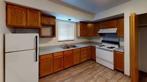 Bellingham apartment for rent - an empty kitchen with white appliances and wooden cabinets