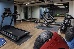 Seattle townhouse for rent - a gym with treadmills and other exercise equipment on a wooden floor