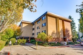 Mercer Island apartment for rent - A large building with a parking lot in front of it.