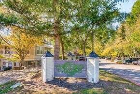 Sammamish apartment for rent - A sign that says "Hillcrest Gardens" is in front of a tree.