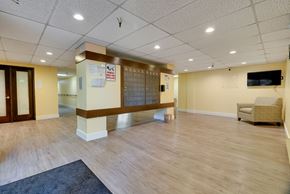 Mercer Island apartment for rent - A spacious room with wooden flooring and a television mounted on the wall.