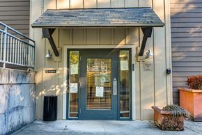 Issaquah apartment for rent - The front door of a building with a sign that reads "The Cottage".