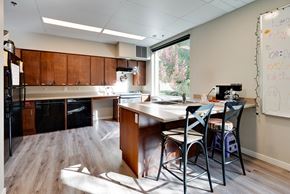 Bellevue apartment for rent - A whiteboard with writing on it sits in a kitchen with a table and chairs.
