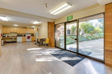 Mercer Island apartment for rent - A kitchen area with a dining table and chairs is visible through a glass door.