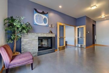 Kirkland apartment for rent - A living room with a fireplace and a painting on the wall.