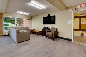 Mercer Island apartment for rent - A living room with a couch, chair, and television.