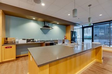 Kirkland apartment for rent - A modern kitchen with a long counter and wooden cabinets.