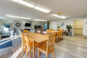 Kirkland apartment for rent - A dining room with a long wooden table and chairs.