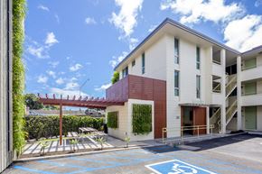 Honolulu apartment for rent - A building with a parking space marked with a wheelchair symbol.
