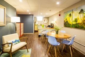 Honolulu apartment for rent - A room with a wooden floor and a painting on the wall.