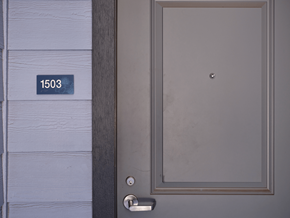 Waikoloa Village apartment for rent - A grey door with a silver handle and a number plate on the wall.
