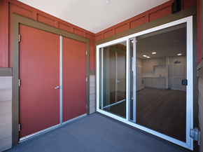 Waikoloa Village apartment for rent - A room with a red door and a glass door leading to another room.